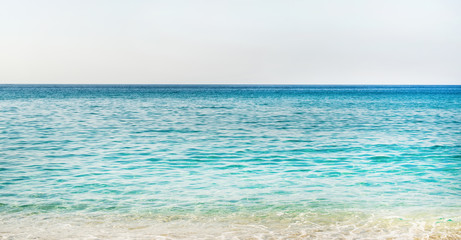 Obraz na płótnie Canvas All shades of marine blue. Turquoise clear blue sea water of Mediterranean sea at Cleopatra beach in Alanya, Antalya region, Turkey coast. Gradient of blue at Turkish Riviera