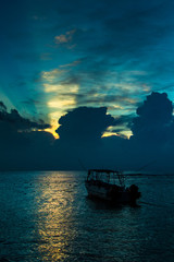 Boat in sea at dawn
