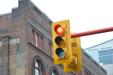 Traffic light in front of the old building in Toronto downtown. Red light.