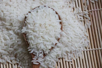 Fototapeten Rice grains raw foods in the spoon wood, non cook © louisnina