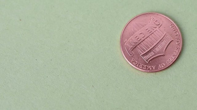 A spinning penny on a green background 