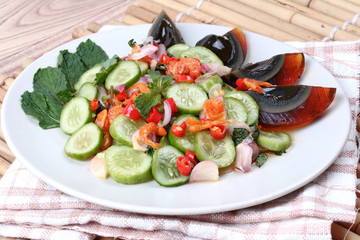 Close up spicy cucumber salad with dried-shrimp and  preserved e