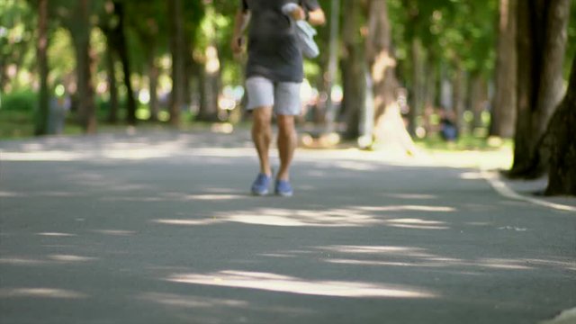 People jogging In the Park, shallow DOF, low angle view