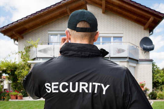 Male Security Guard Standing Outside The House