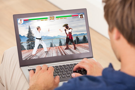 Man Playing Videogame On Laptop