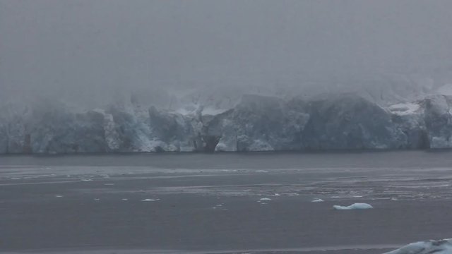 Harsh glaciers of high Arctic latitudes. ice fabric, icefall on Northbrook Isl., Franz-Joseph Land. Foggy snowy weather in late July 2016.
