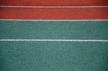 Fototapeta premium Closeup of running track with parallel white lines