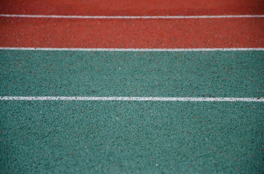 Closeup of running track with parallel white lines