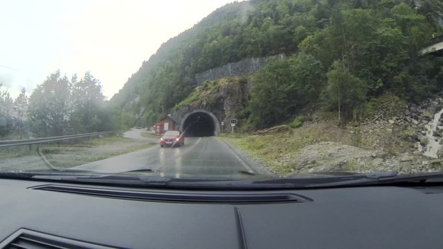 Norway .  Car leaves from the tunnel. The view from the car on the road