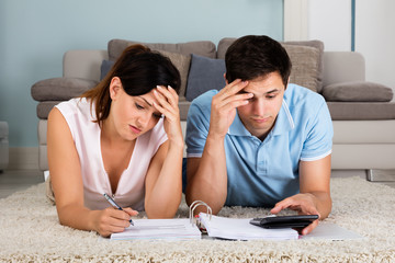 Unhappy Couple Calculating Bills