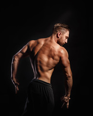 Fototapeta na wymiar Bodybuilder Posing. Back muscles.