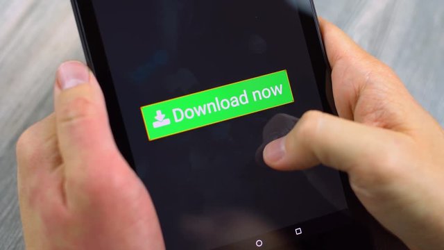 Man holding a tablet, pressing a big green download button