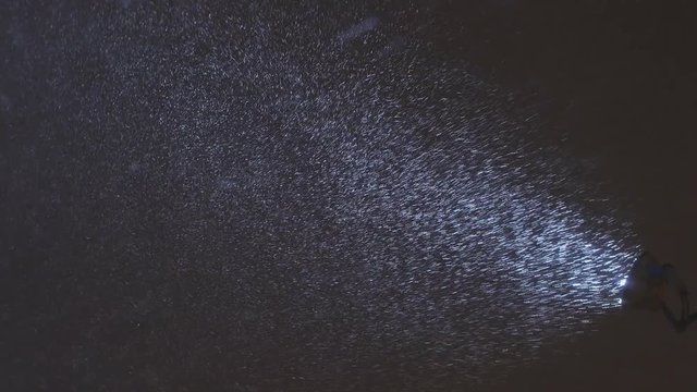Snowfall in beam of projector at night 1