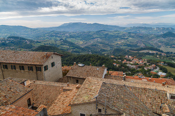 Fototapeta na wymiar The State of San Marino in Italy, tiled roofs and green hills