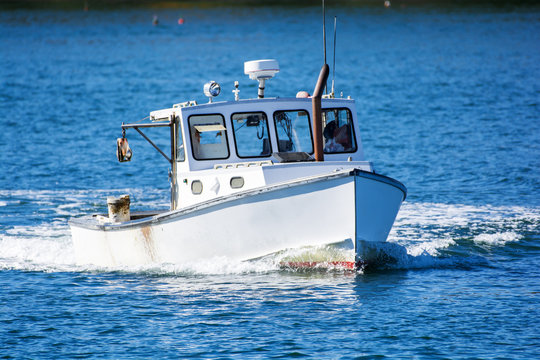 Lobster Fishing Boat In Autumn Against Deep Blue Ocean Water In Coastal Maine, New England