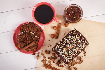 Cup of coffee and dark cake with chocolate, cocoa and plum jam, delicious dessert