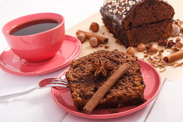 Dark cake with chocolate, cocoa and plum jam, cup of coffee, delicious dessert