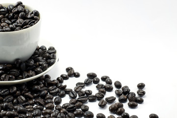 Coffee beans in coffee cup isolated on white
