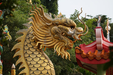 golden dragon statue on the roof of chinese temple