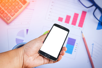 Business concept area work have laptop, chart and smart phone. The blank screen with copy space for your text in smart phone.