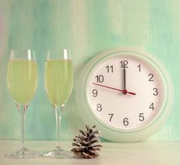 Sparkling wine with pine cone and clock showing midnight