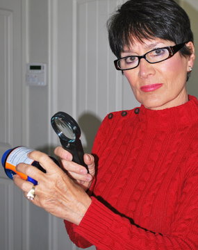 Mature Female Beauty Reading A Medicine Bottle Label.