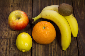 Mixed fruit on a wooden background