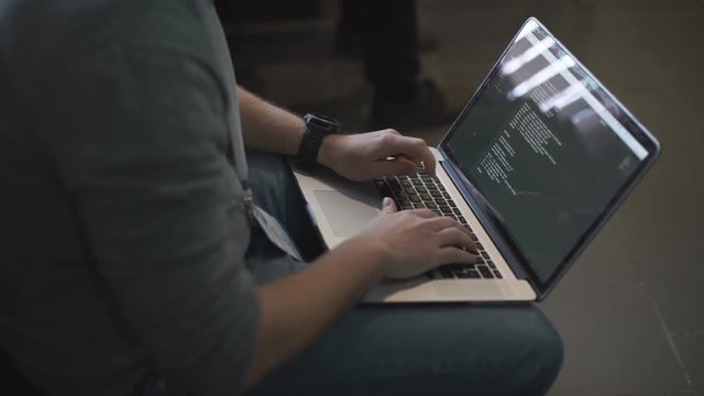 Programmer occupation - writing programming code on laptop