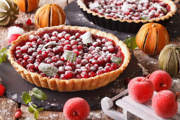 Delicious Christmas cranberry tart and festive decoration close-up. Horizontal