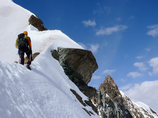 a mountain climber on an exposed ridge in the Swiss Alps near Zermatt