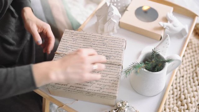Woman unties the rope and unpacks paper box, unpacking christmas presents, mail box openning