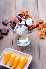 Ice cream sundae, chocolate, walnuts and sliced orange 