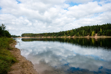 calm lake with reflections of clouds  in summer