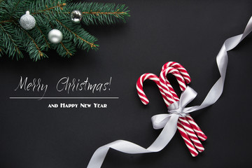 Christmas or New Year decoration background. Fir tree branches on black background with copy space. Top view. Pattern.