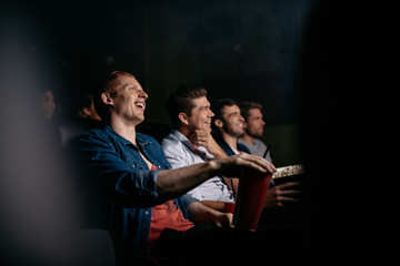 Young people watching comedy movie in theater