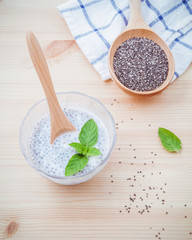Nutritious chia seeds museli  and peppermint leaves with wooden