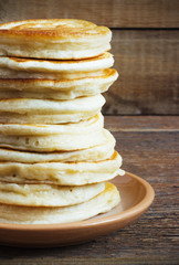 stack of pancakes on a wooden background
