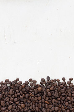 coffee beans on grain white wood background