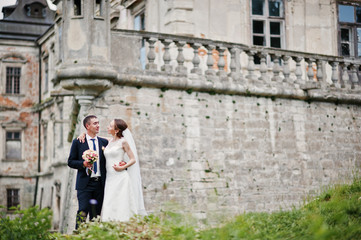 Wedding couple background old vintage castle. Happy newlyweds at