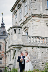 Fototapeta na wymiar Wedding couple background old vintage castle. Happy newlyweds at