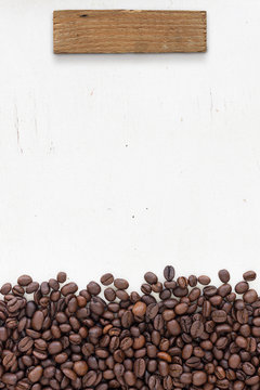 coffee beans on grain white wood background