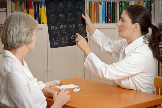 female doctor senior patient MRI