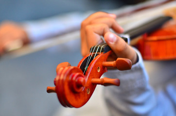 Child playing a violin. Blur style background.