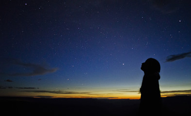 Silhouette of woman looking at Stars