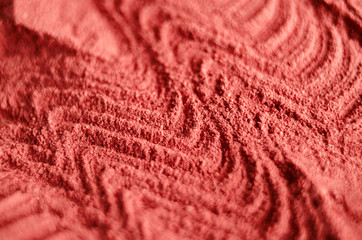 Red moroccan cosmetic clay powder texture close up, selective focus. Abstract background. 