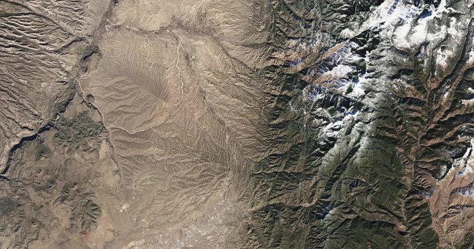 High-altitude overflight aerial of the Sangre de Cristo foothills and mountains, NM. Clip loops and is reversible. Elements of this image furnished by NASA 