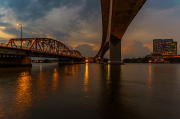 Two bridges "Krungthep bridge" and "Rama3 bridge" cross over the main river "Chao praya river" bangkok,thailand in twilight period.
