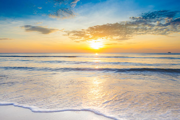 Fototapeta na wymiar Bright sunrise over on the beach