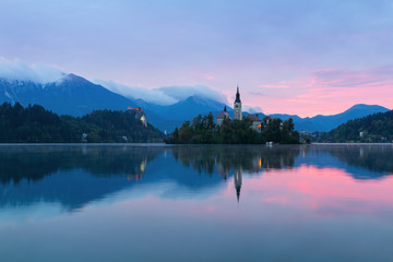 Fototapeta na wymiar Lake Bled and the island with the church at autumn color at sunset in Slovenia