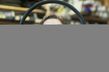 Woman in bicycle repair shop quality checking inner tube